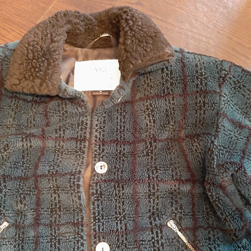 dark green and black jacket, good for after skiing